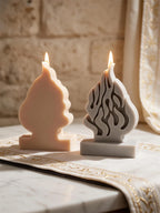 Flat rear of cream flame casting beside front-facing gray casting with flame relief