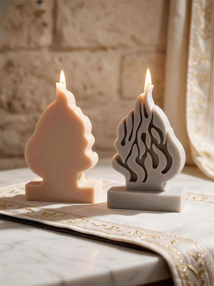 Flat rear of cream flame casting beside front-facing gray casting with flame relief
