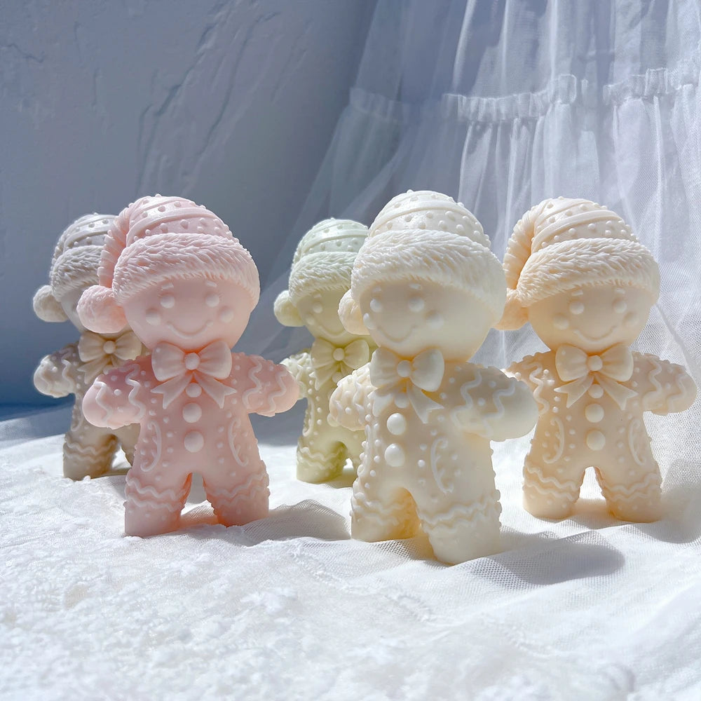 Pink and ivory winter gingerbread figure candles with bow ties