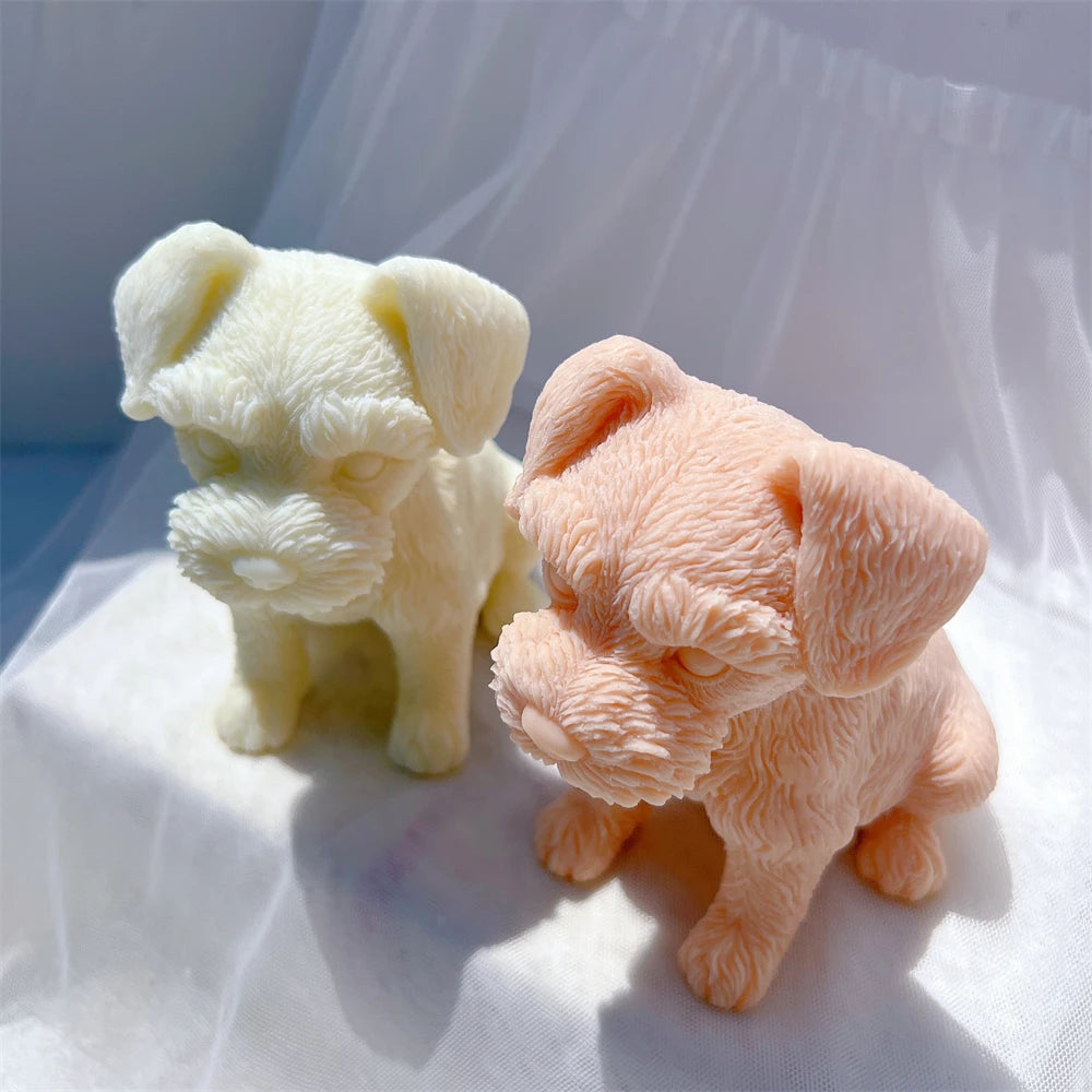 Puppy candles in cream and peach showing their tails and sculpted coats