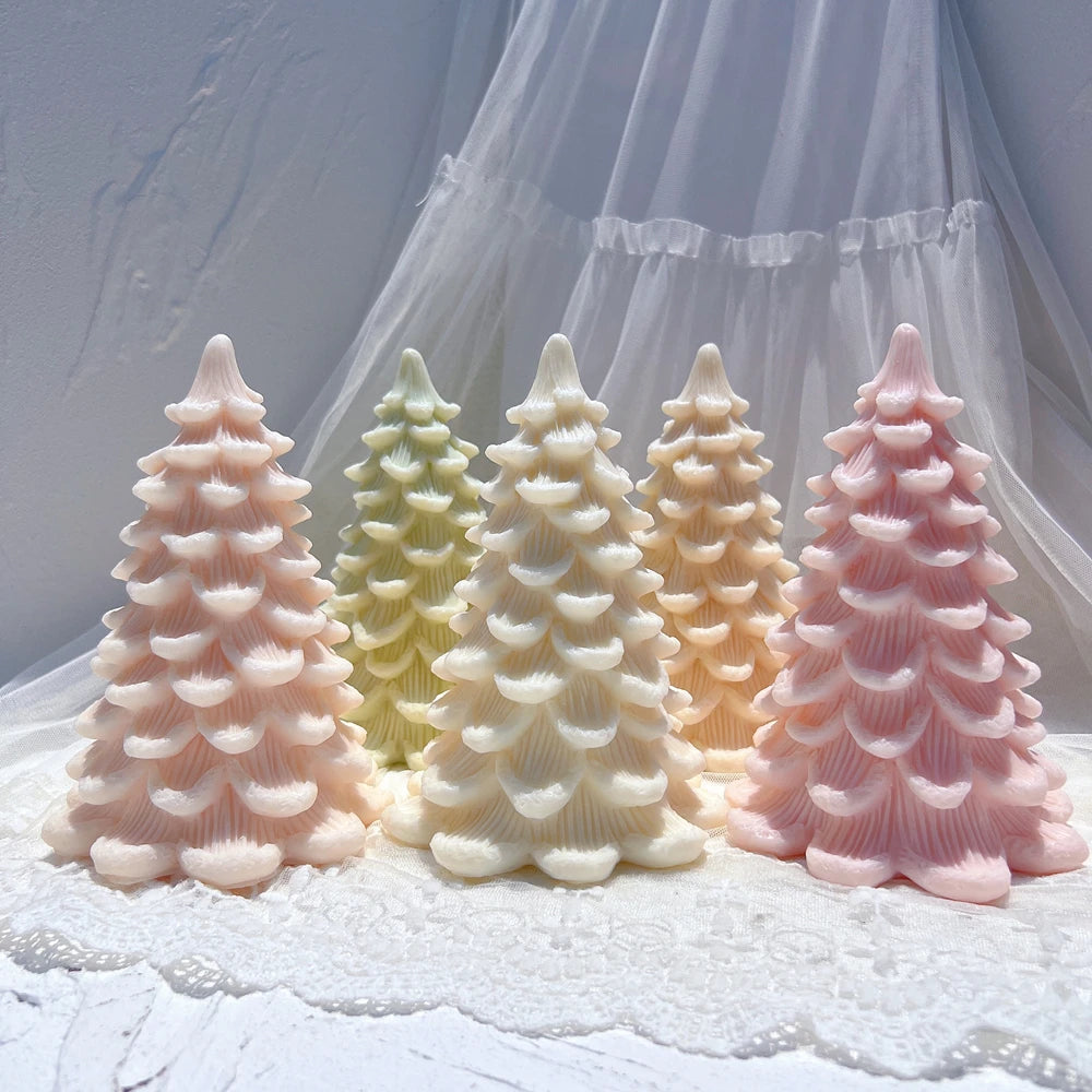 Four scalloped tree castings with broad lower branch layers