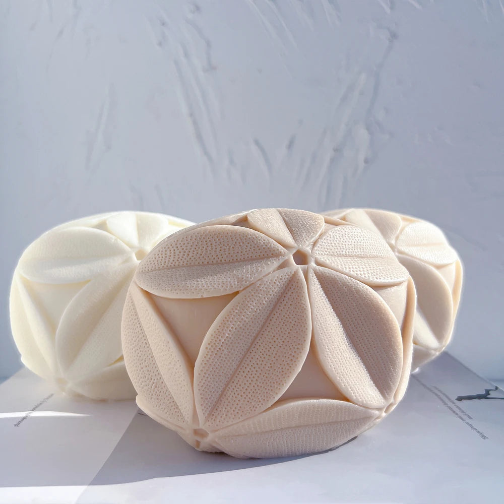 Cream and beige leaf-pattern cube castings viewed from the front