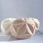 Cream and beige leaf-pattern cube castings viewed from the front