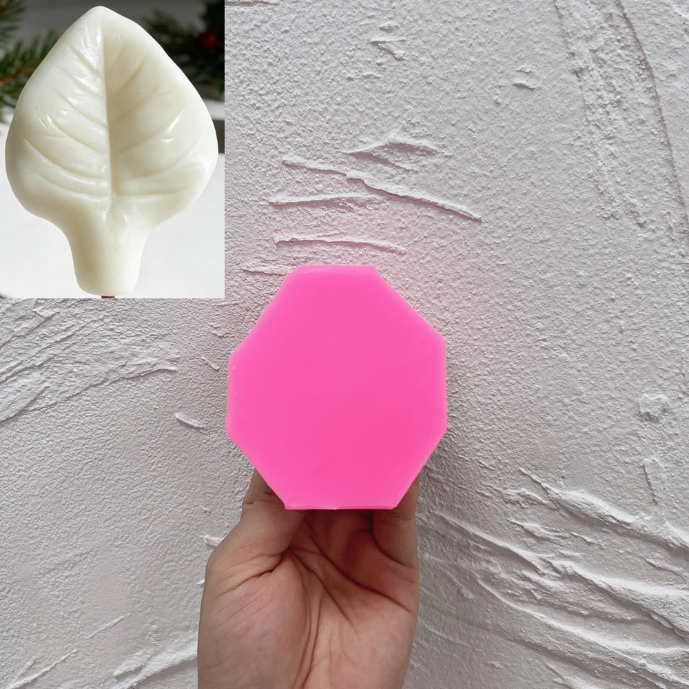 Pink silicone mold for the veined lilac leaf design beside finished example