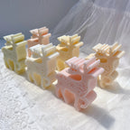 Top angled view of pastel reindeer candles with snowflake reliefs