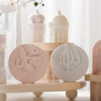 Circular calligraphy plaques displayed in front of domed architectural forms