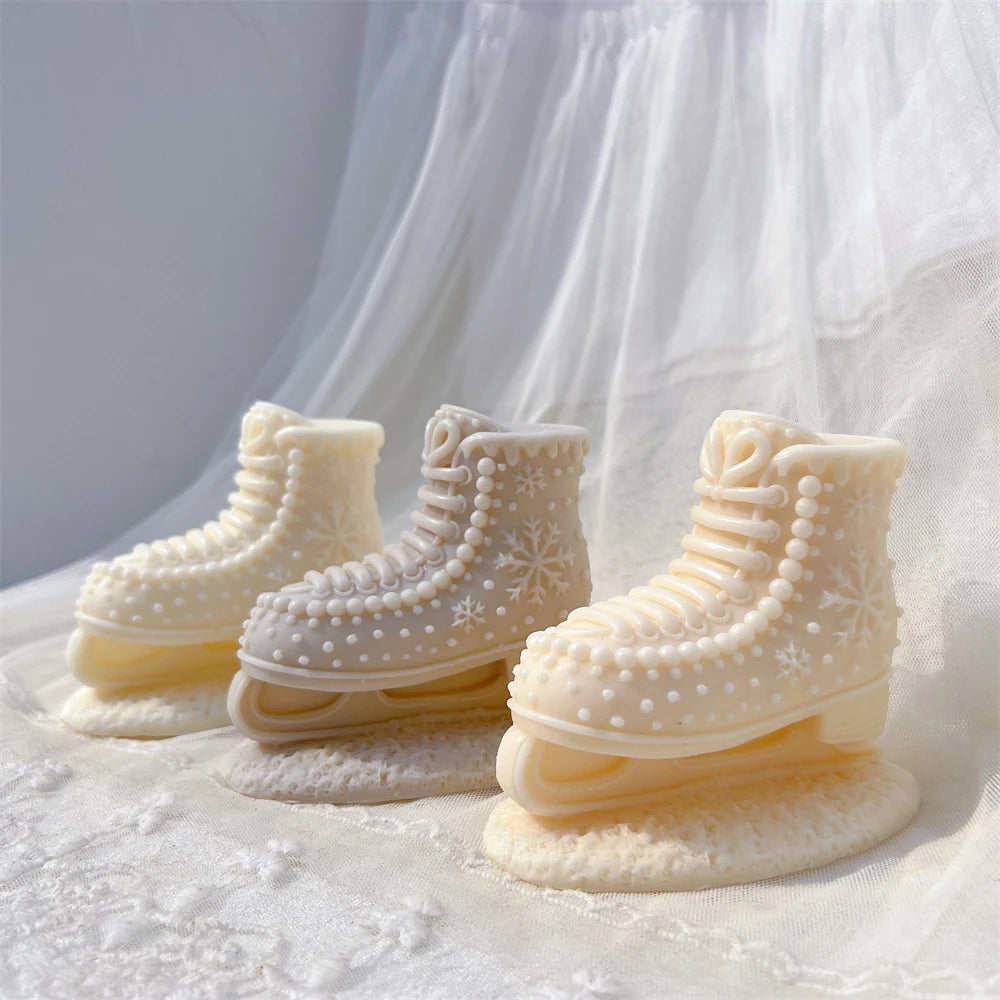 Cream and beige ice skate boot candles with lace-up fronts and snowflakes