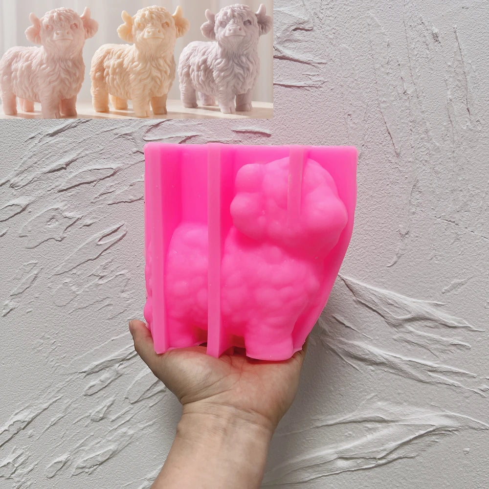 Pink standing Highland cow silicone mold held in one hand