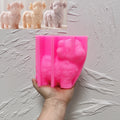 Pink standing Highland cow silicone mold held in one hand