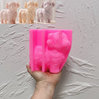 Pink standing Highland cow silicone mold held in one hand