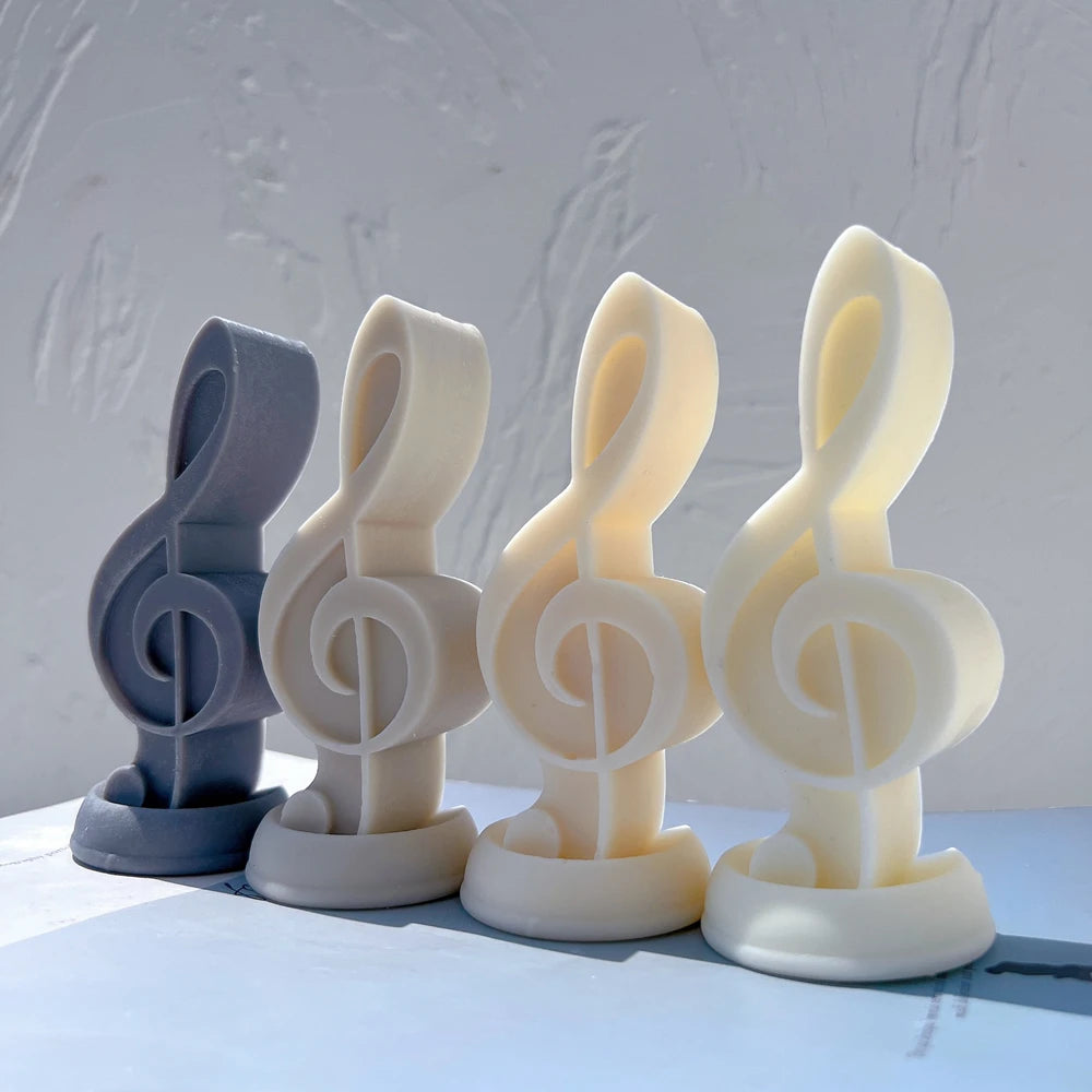 Four treble clef castings in blue and neutral colors