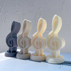 Four treble clef castings in blue and neutral colors
