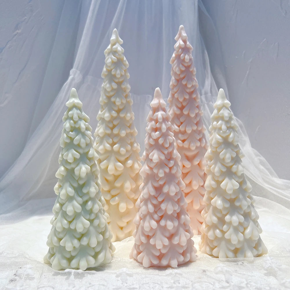 Tall Christmas tree candles with layered snow-like branches
