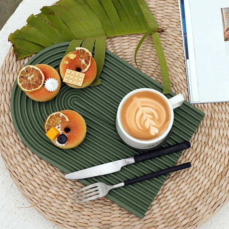 Green circular ribbed tray with cups and food display props