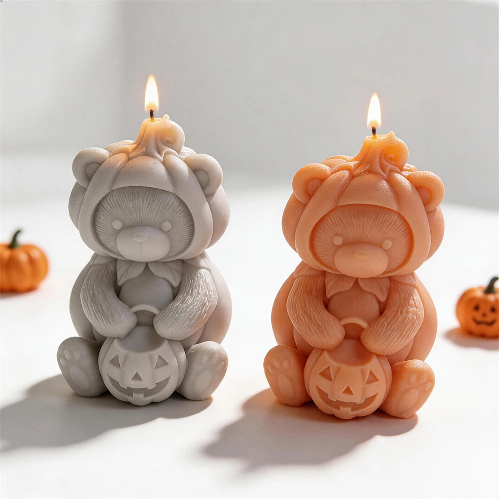 Seated bear candles with jack-o'-lanterns between their paws