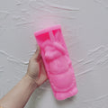 Pink bonnet-and-apron rabbit silicone mold held in one hand