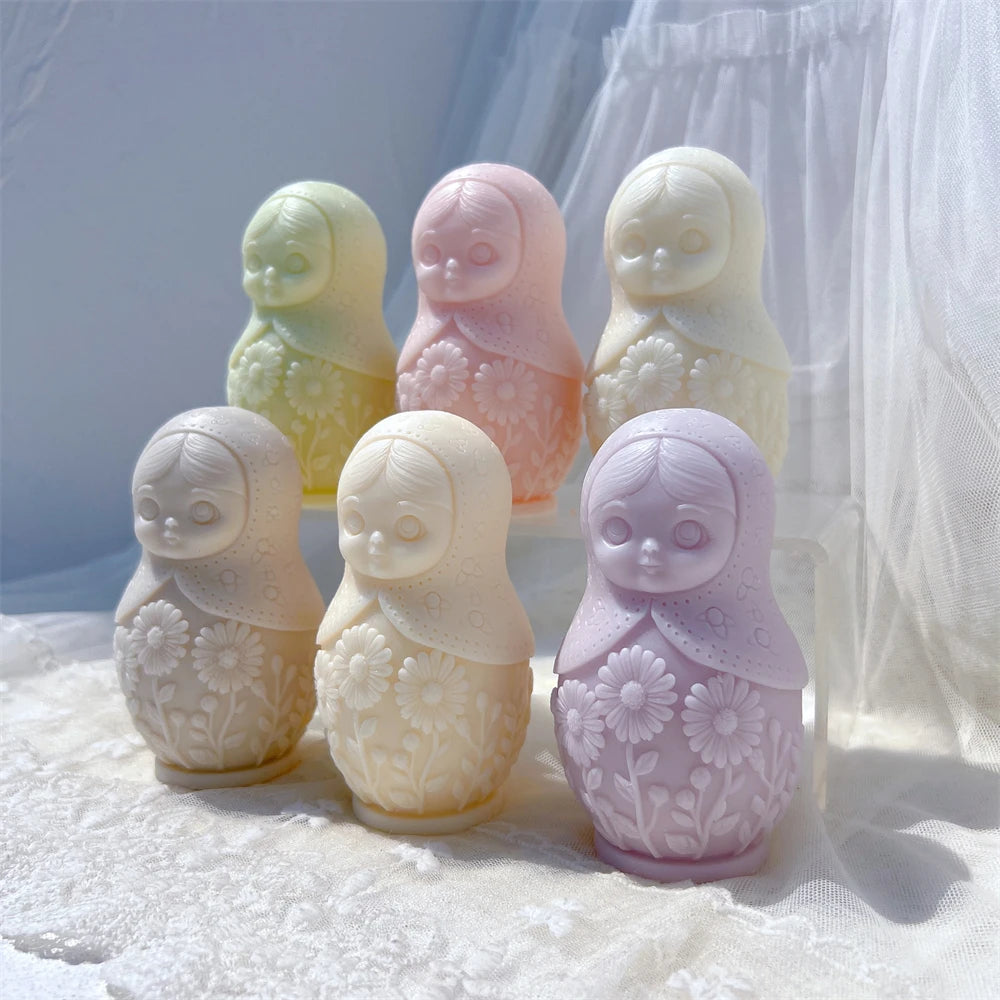 Pastel Russian doll figures with raised decorative patterns and rounded bases