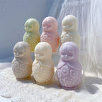 Pastel Russian doll figures with raised decorative patterns and rounded bases