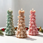 Pastel bell-shaped Christmas tree candles with bows at the top