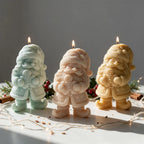 Gnome and gingerbread man candles on a festive surface