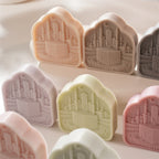 Angled display of Kaaba plaques on a round stand