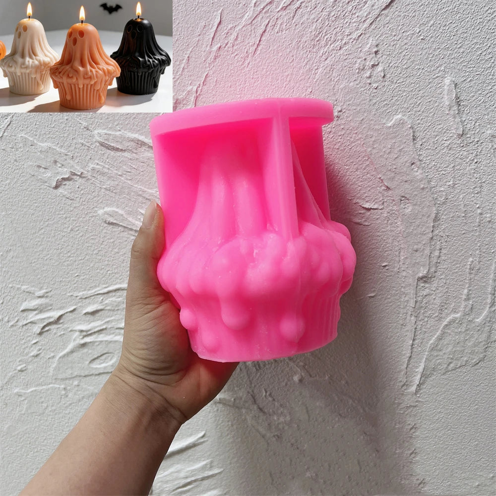 Pink ghost cupcake silicone candle mold held in one hand