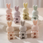 Sleepy bunnies holding round-petal flowers