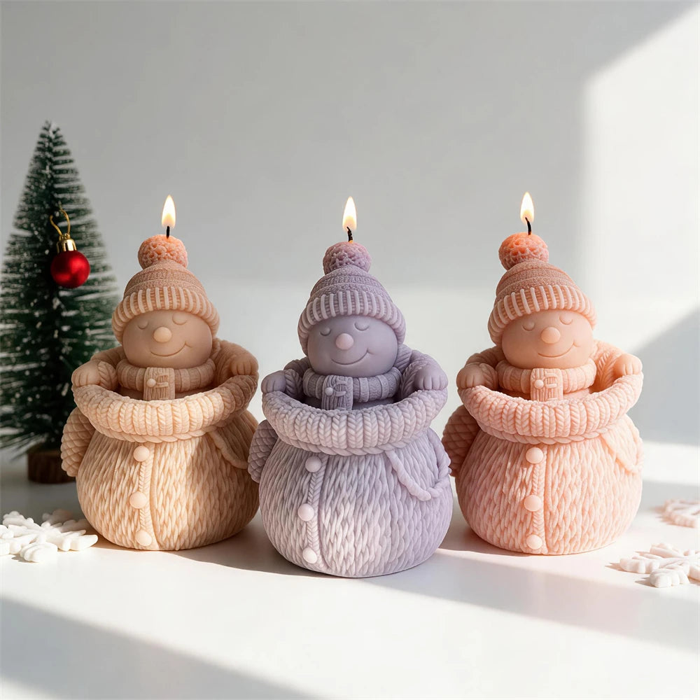 Snowman candles arranged with Christmas decorations