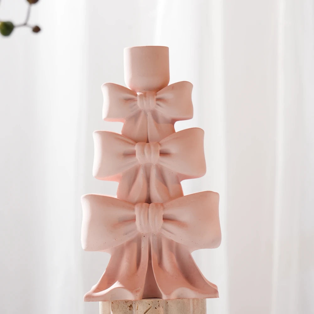 Pink stacked bow holder showing sculpted loops and ribbon tails