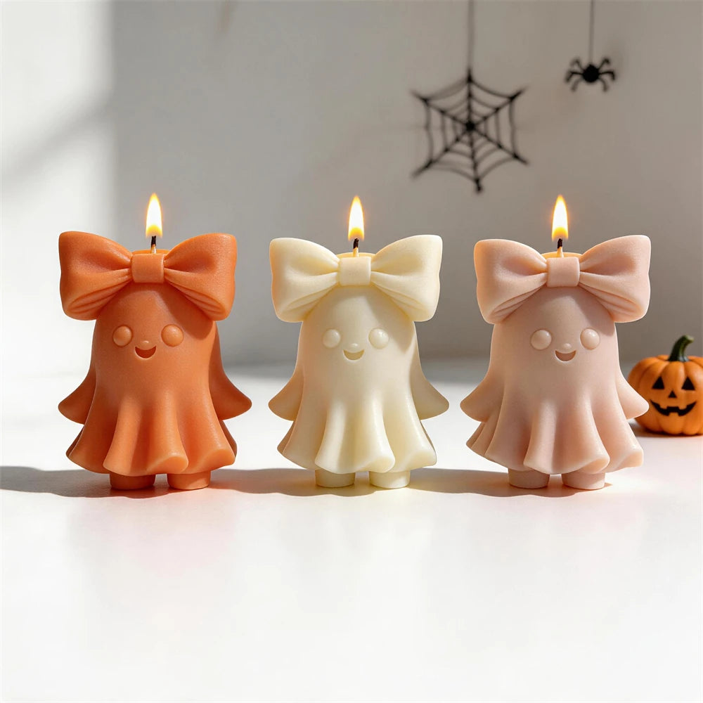 Three ghost figures with wide ribbon bows