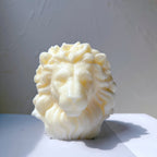 Front close-up of light-colored lion-head casting with wavy textured mane