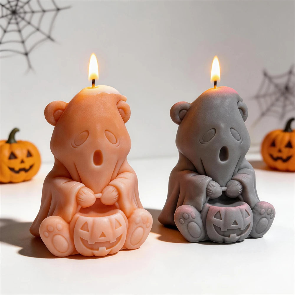 Front view of ghost bear candles with bow ties, paws and open-mouthed faces