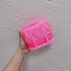 Pink leaf-petal cube silicone mold held in one hand