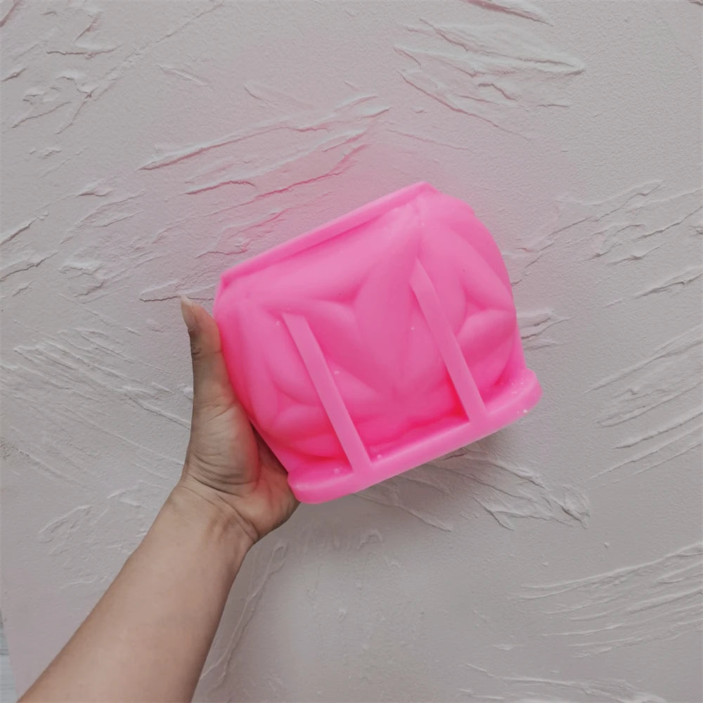 Pink leaf-petal cube silicone mold held in one hand