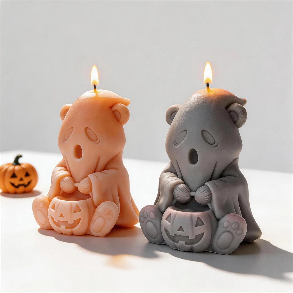 Orange and gray ghost bear candles holding jack-o'-lanterns