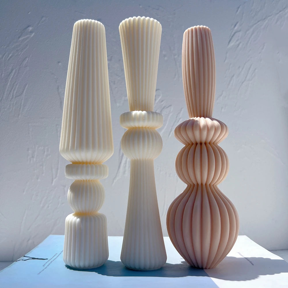 Tall sculptural ribbed candles in cream and peach