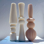 Tall sculptural ribbed candles in cream and peach