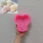 Pink silicone rose bouquet and bow mold held in a hand