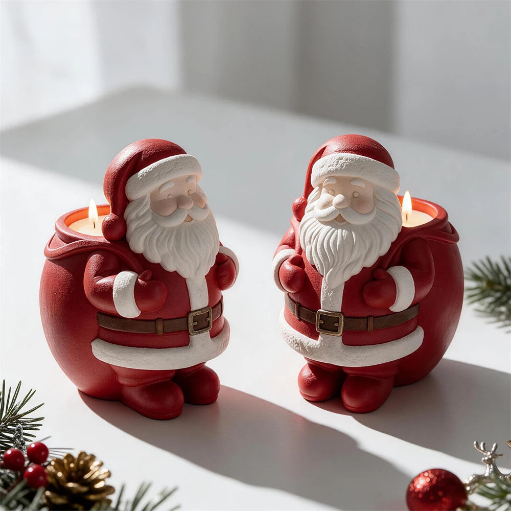 Two Santa-themed decorative castings beside a rounded red container in Christmas colors