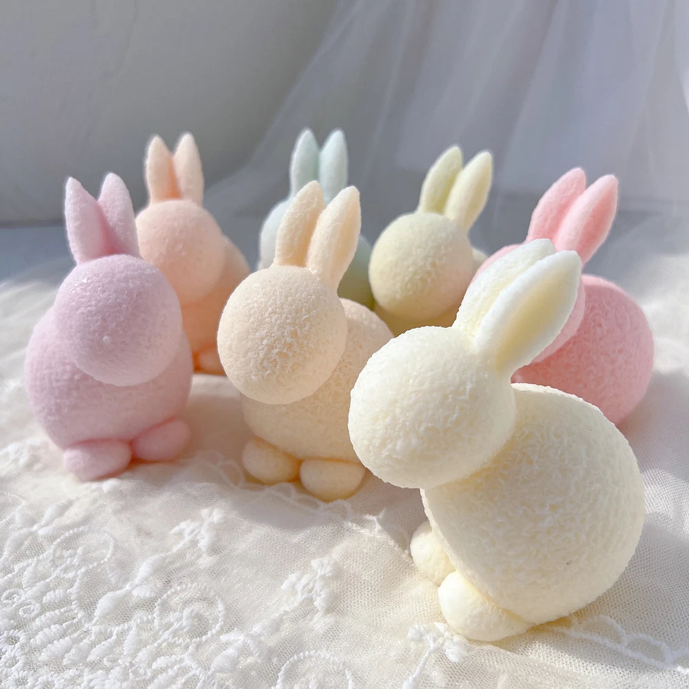 Cluster of plush-textured crouching rabbits with long ears