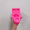 Pink cat holder silicone mold showing the open belly and cup-forming area