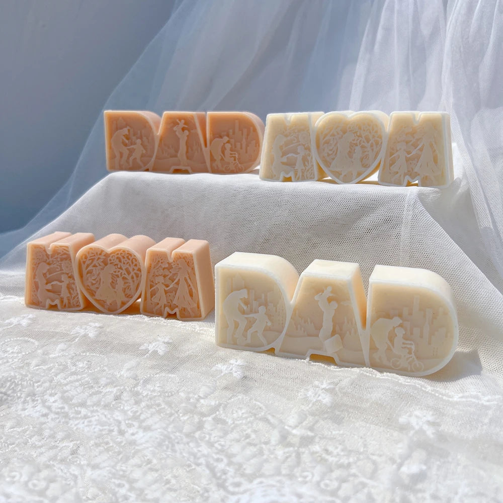 Decorative DAD lettering and heart-centered MOM designs on white fabric