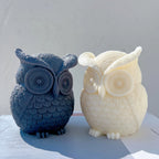 Angled owl candle pair showing raised brow tufts