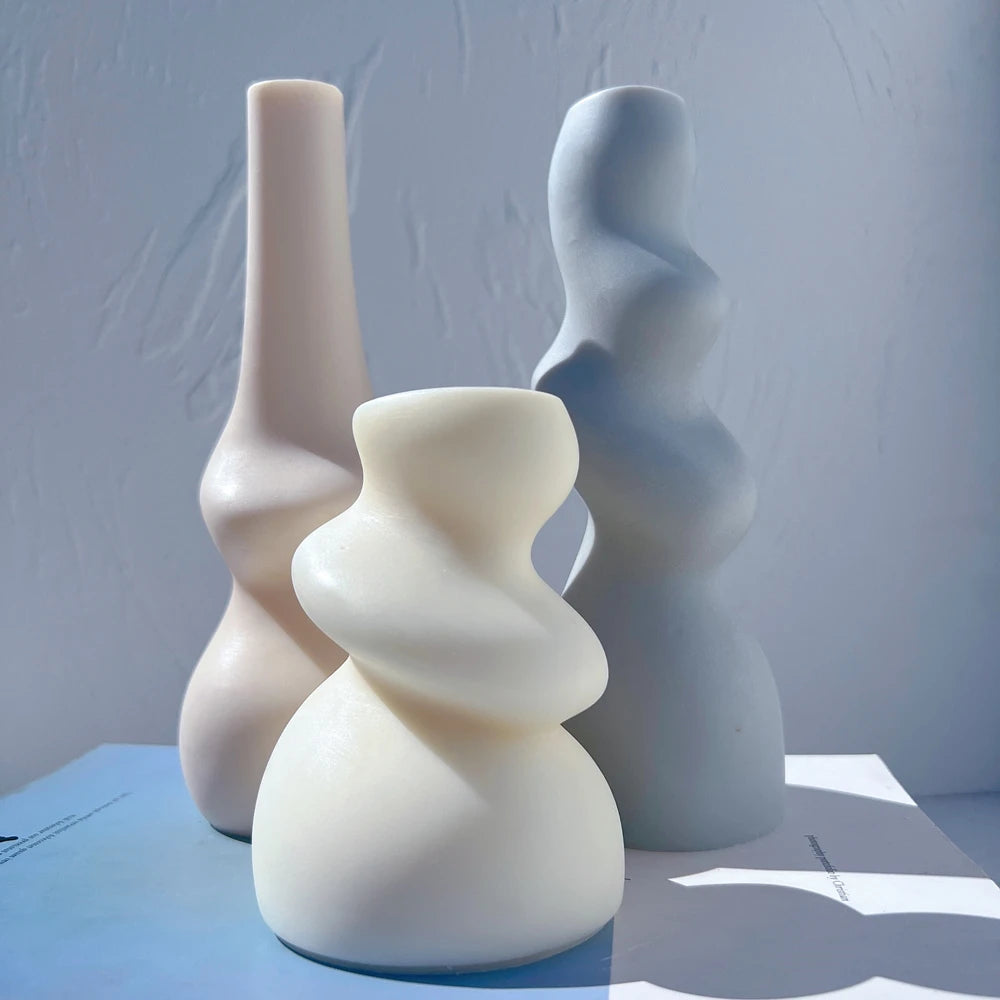 Smooth abstract candle shapes showing rounded bulges and broad bases