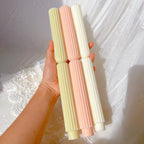 Three ribbed waisted taper castings held in one hand