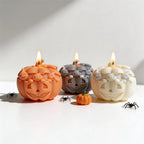 Three smiling ghost-topped pumpkin castings with Halloween props