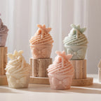 Bow-front cupcakes with tall swirled tops in pastel colors