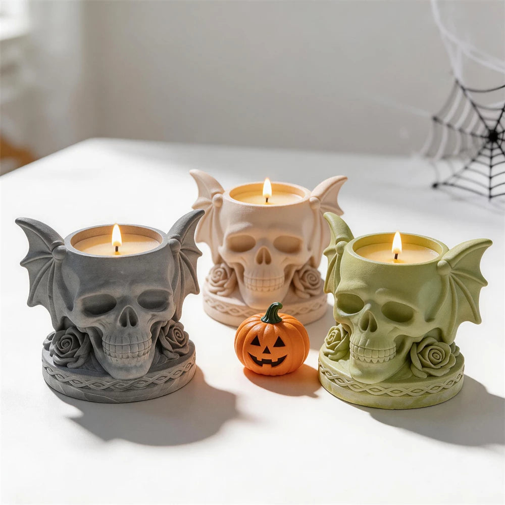 Three gothic skull holder castings with candles in top recesses