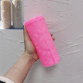 Pink moon mandala silicone pillar mold held beside finished castings