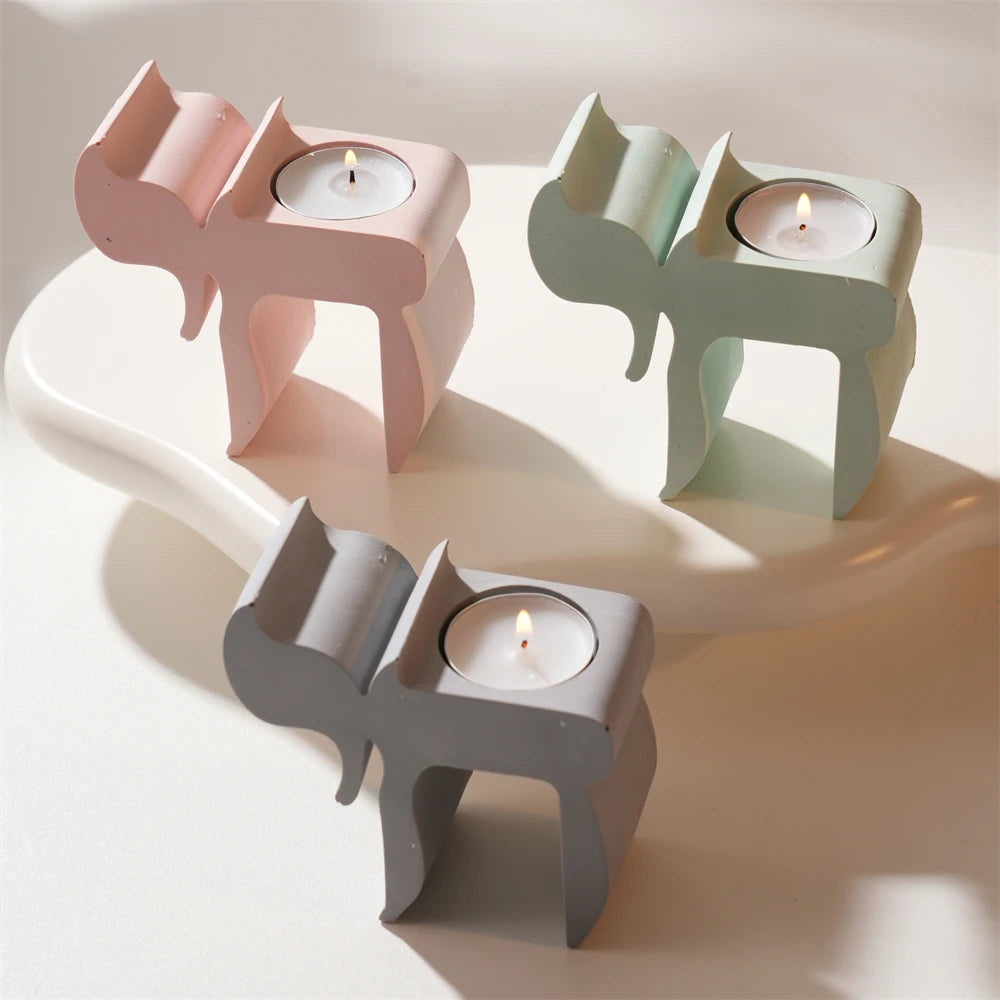 Chai-inspired decorative tealight holders in gray green and pink castings